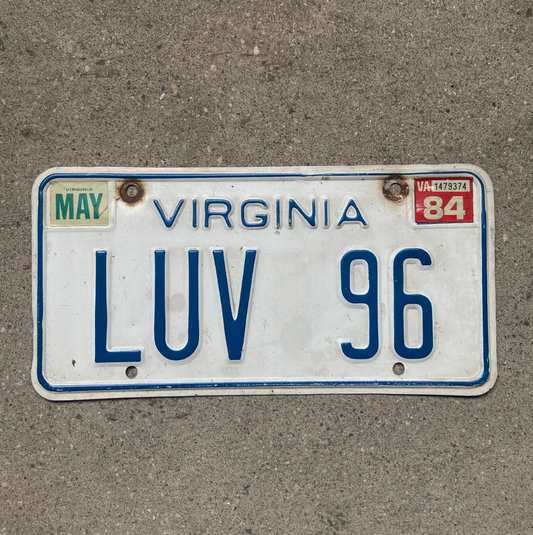 Photo of a 1973 1984 Virginia Vanity License Plate LUV 96 1996 September 6th Wedding For Lovers on a concrete background