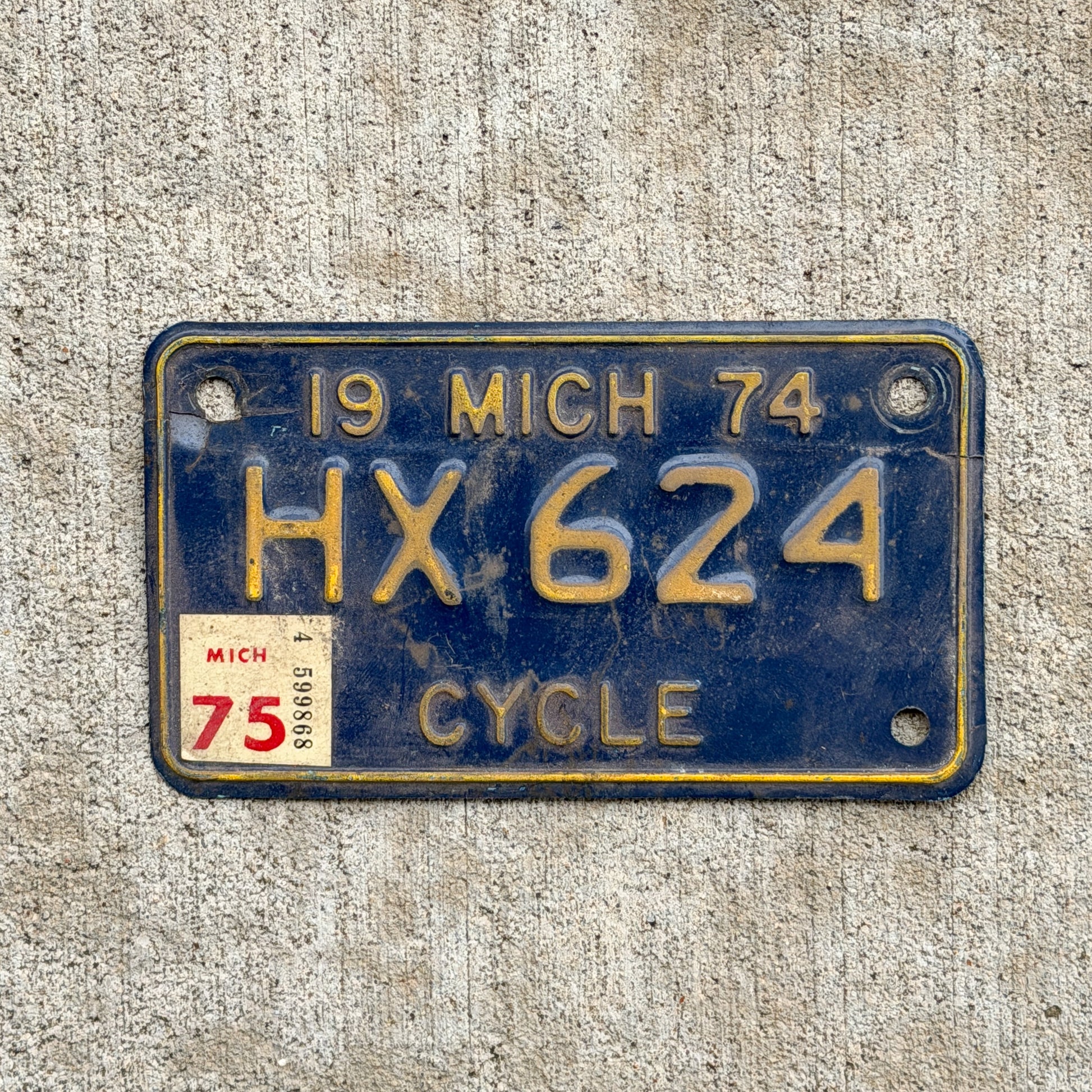 Photo of a 1974 1975 Michigan Motorcycle License Plate Auto Tag Garage Decor Vintage HX 624 with original patina