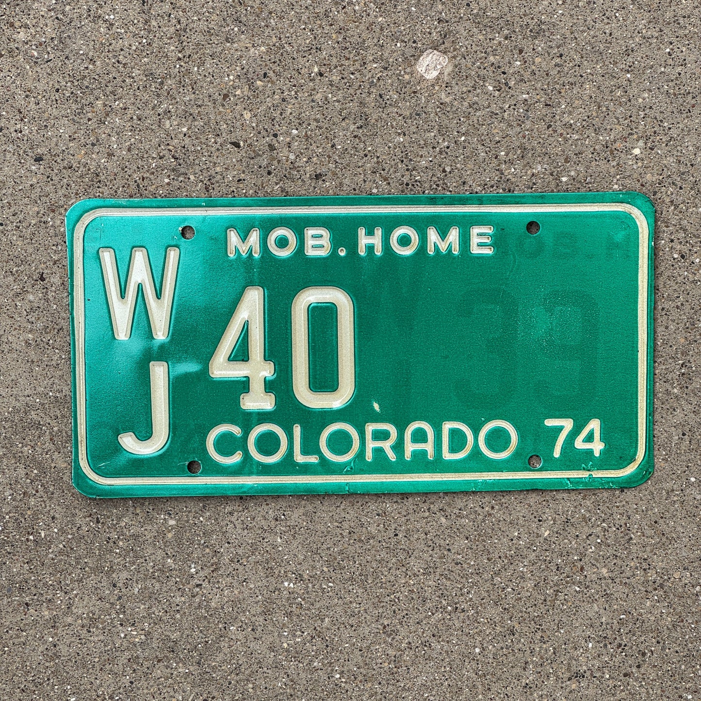 Photo of a 1974 Colorado Mobile Home License Plate Auto Tag Garage Decor Vintage WJ 40