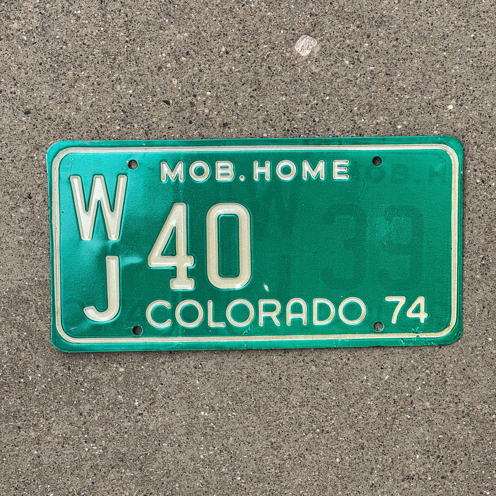 Photo of a 1974 Colorado Mobile Home License Plate Auto Tag Garage Decor Vintage WJ 40