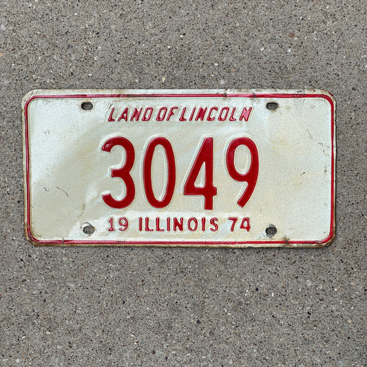 Photo of a 1974 Illinois License Plate Auto Tag Garage Decor Vintage Low Number Four Digit 3049 with original patina
