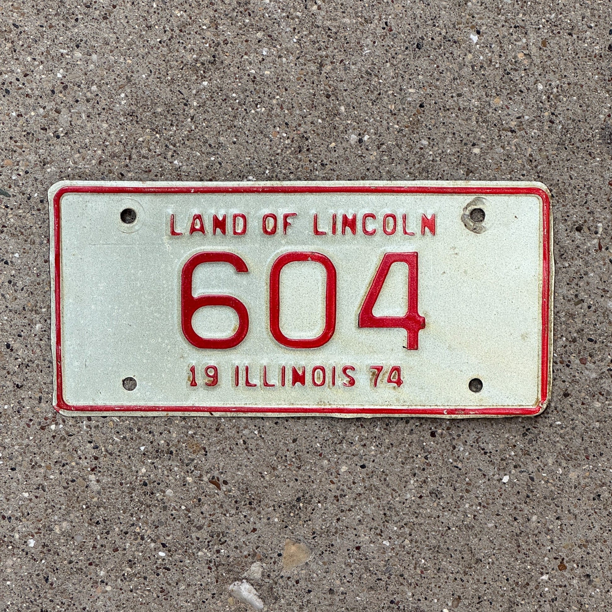 Photo of a 1974 Illinois Motorcycle License Plate Auto Tag Garage Decor Vintage Low Number Three Digit 604 with original patina