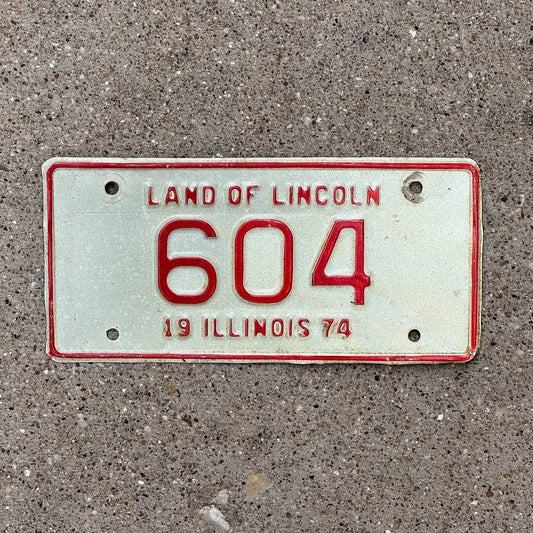 Photo of a 1974 Illinois Motorcycle License Plate Auto Tag Garage Decor Vintage Low Number Three Digit 604 with original patina