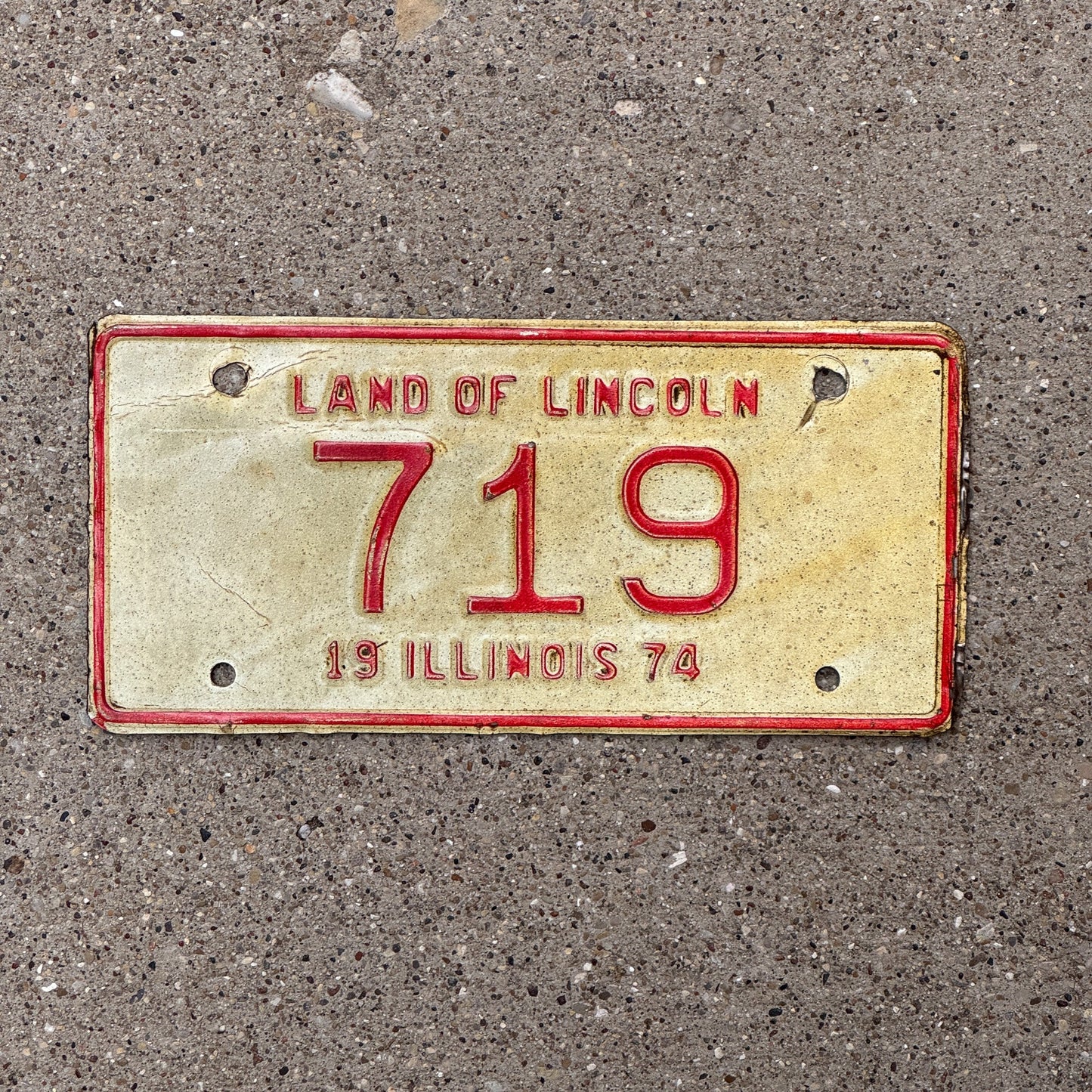 Photo of a 1974 Illinois Motorcycle License Plate Auto Tag Garage Decor Vintage Low Number Three Digit 719 with original patina