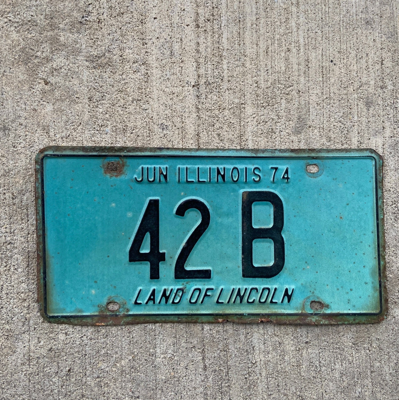 Photo of a 1974 Illinois Truck License Plate Auto Tag Garage Decor Vintage Low Number Two Digit 42 B with original patina