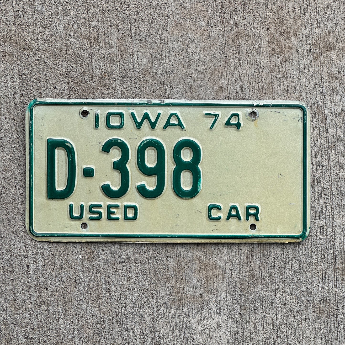 Photo of a 1974 Iowa Used Car Dealer License Plate Auto Tag Garage Decor Vintage D 398 with original patina