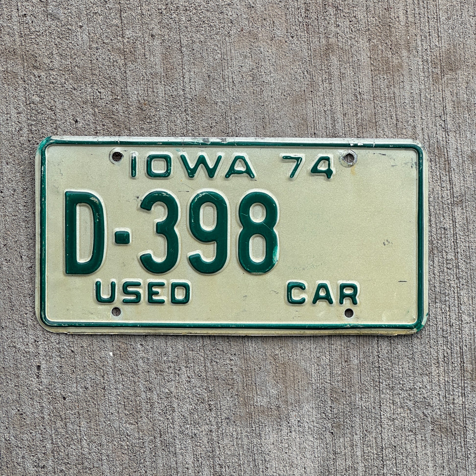 Photo of a 1974 Iowa Used Car Dealer License Plate Auto Tag Garage Decor Vintage D 398 with original patina