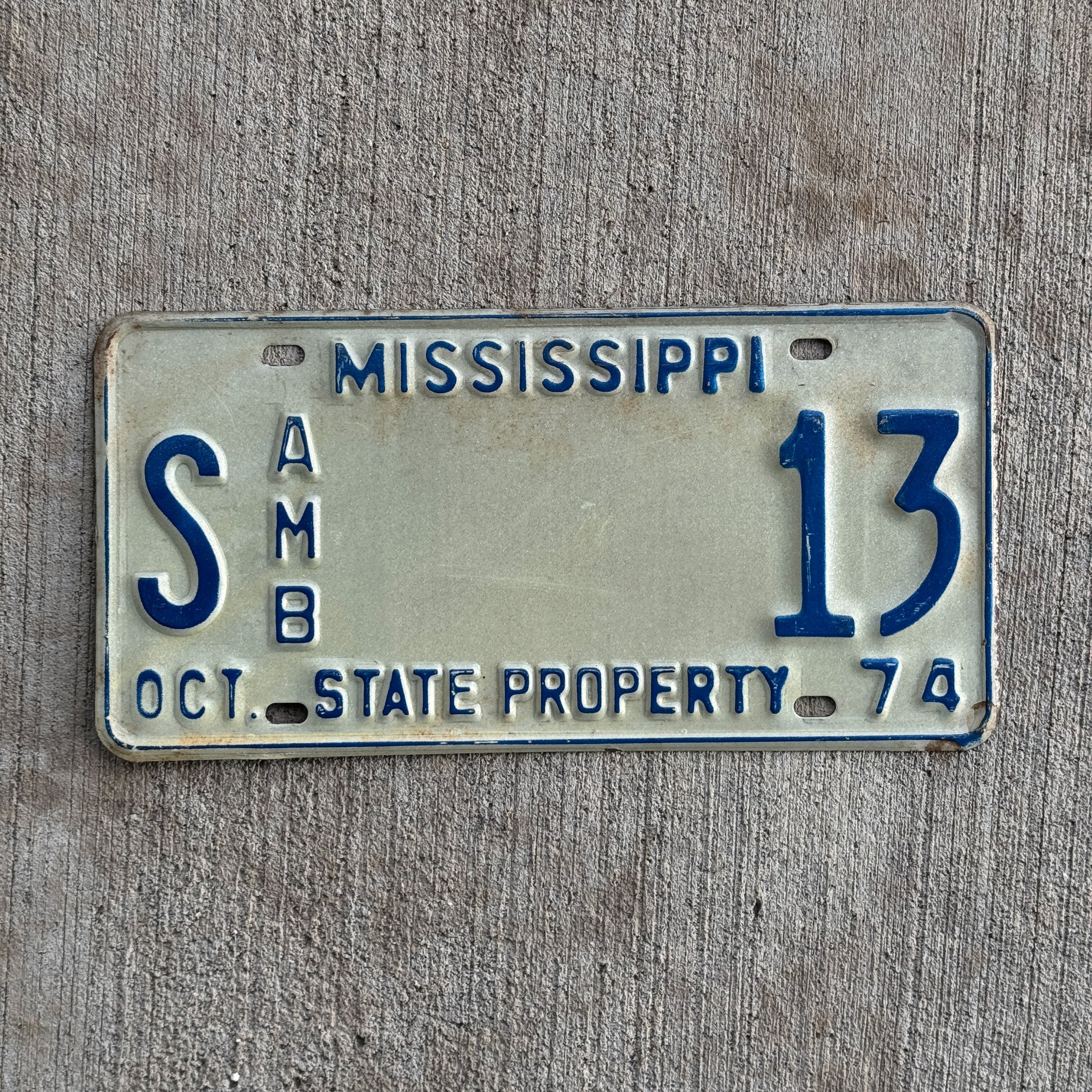 Photo of a 1974 Mississippi State Ambulance License Plate Auto Tag Garage Decor Vintage Lucky Number S 13 with original patina