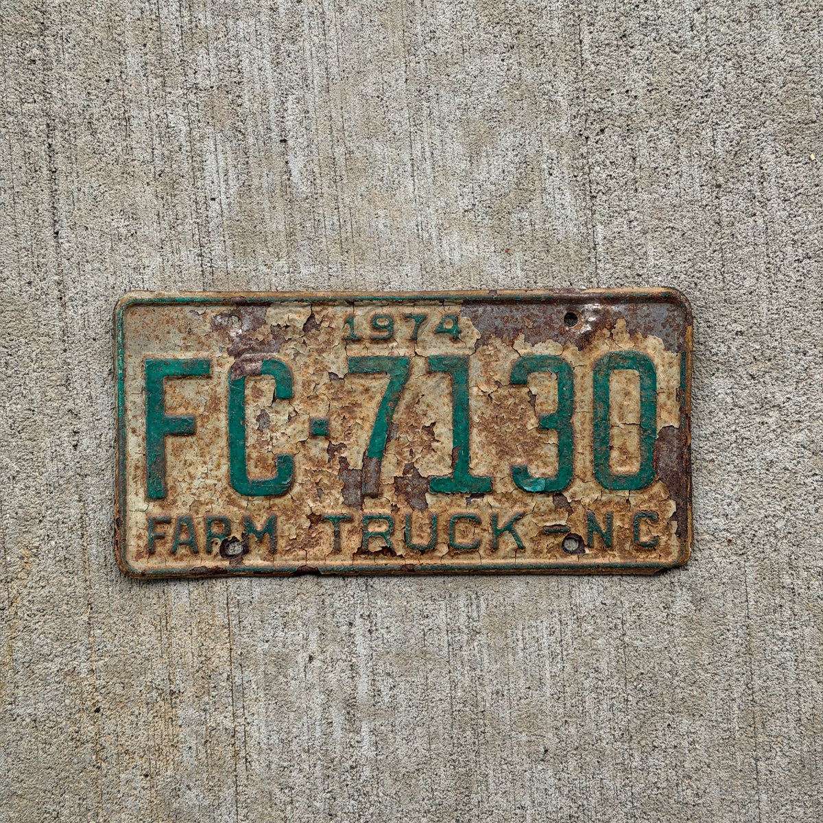 Photo of a 1974 North Carolina Farm Truck License Plate Auto Tag Garage Decor Vintage FC 7130 with original patina