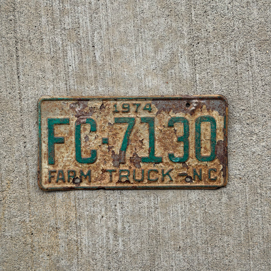 Photo of a 1974 North Carolina Farm Truck License Plate Auto Tag Garage Decor Vintage FC 7130 with original patina