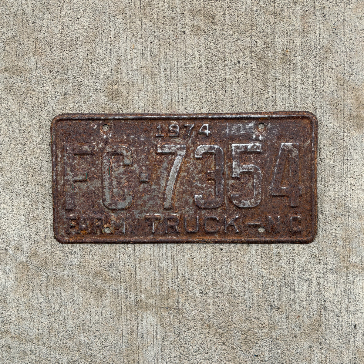 Photo of a 1974 North Carolina Farm Truck License Plate Auto Tag Garage Decor Vintage FC 7354 with original patina