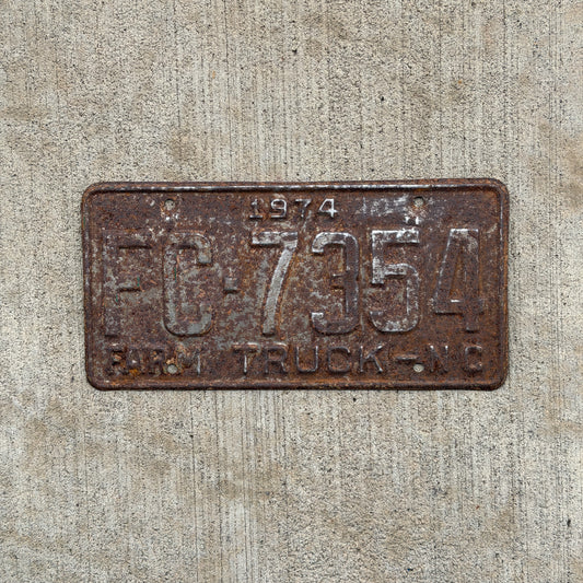 Photo of a 1974 North Carolina Farm Truck License Plate Auto Tag Garage Decor Vintage FC 7354 with original patina