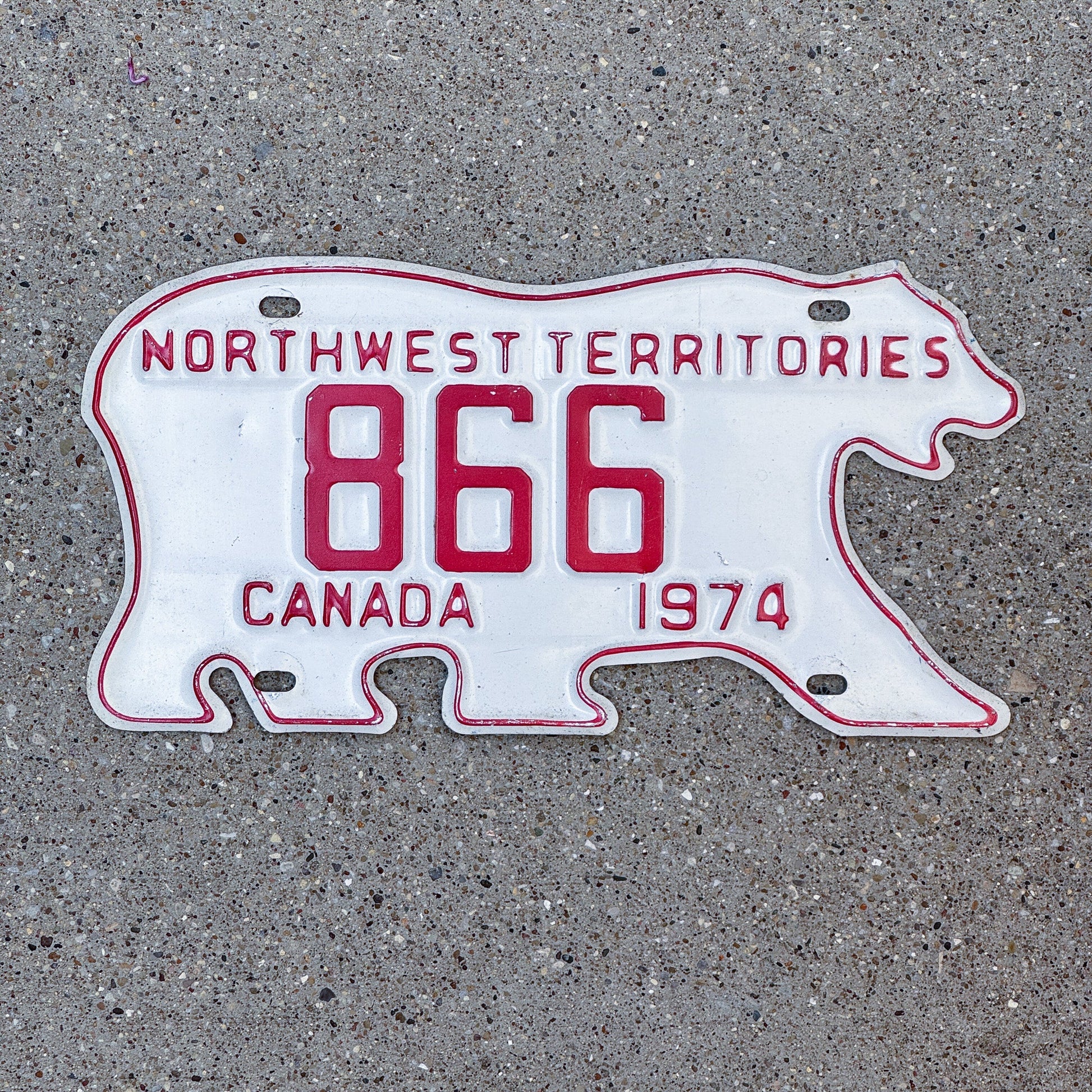 Photo of a 1974 Northwest Territories License Plate Auto Tag Garage Decor Vintage Low Number Four Digit Bear 866