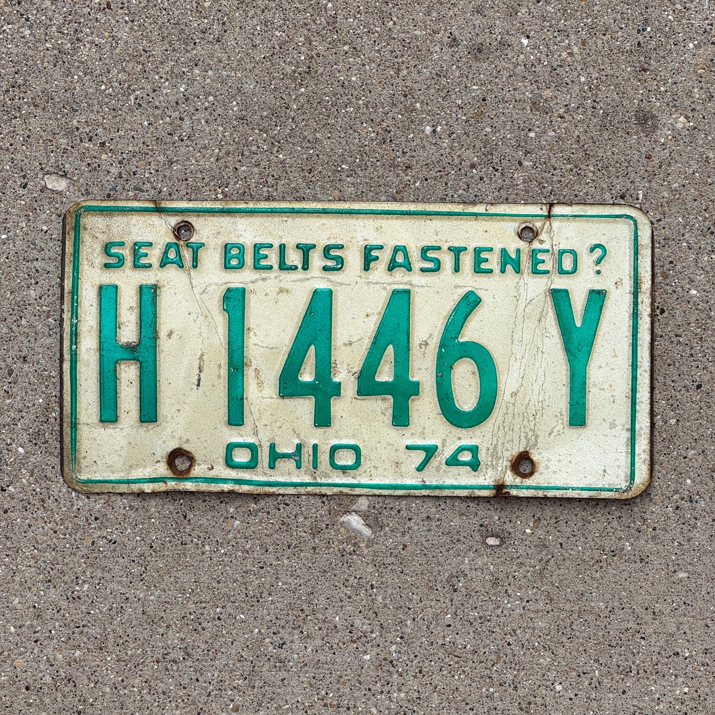 Photo of a 1974 Ohio License Plate Auto Tag 1 Vintage Garage H 1446 Y with original patina