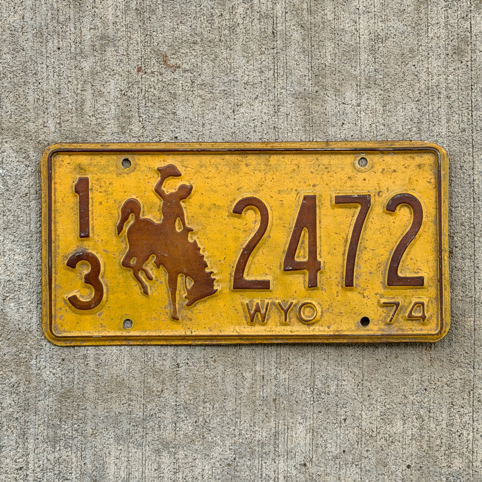 Photo of a 1974 Wyoming License Plate Auto Tag Garage Decor Vintage Cowboy Rodeo 13 2472 with original patina