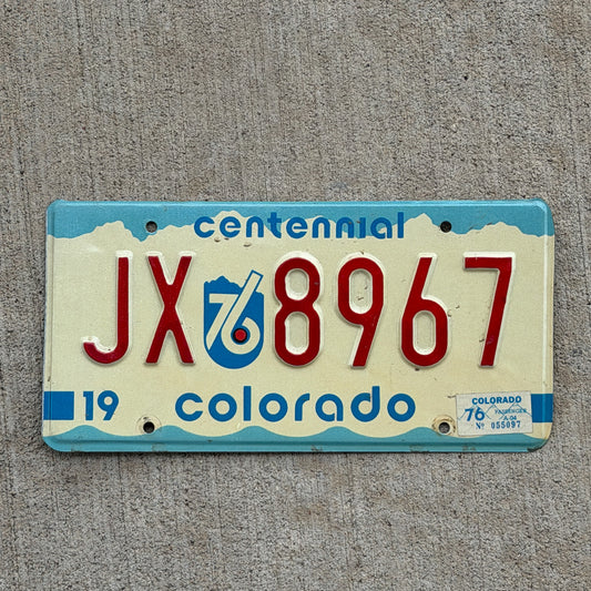 Photo of a 1975 1976 Colorado License Plate Auto Tag Garage Decor Vintage Bicentennial JX 8967 with original patina