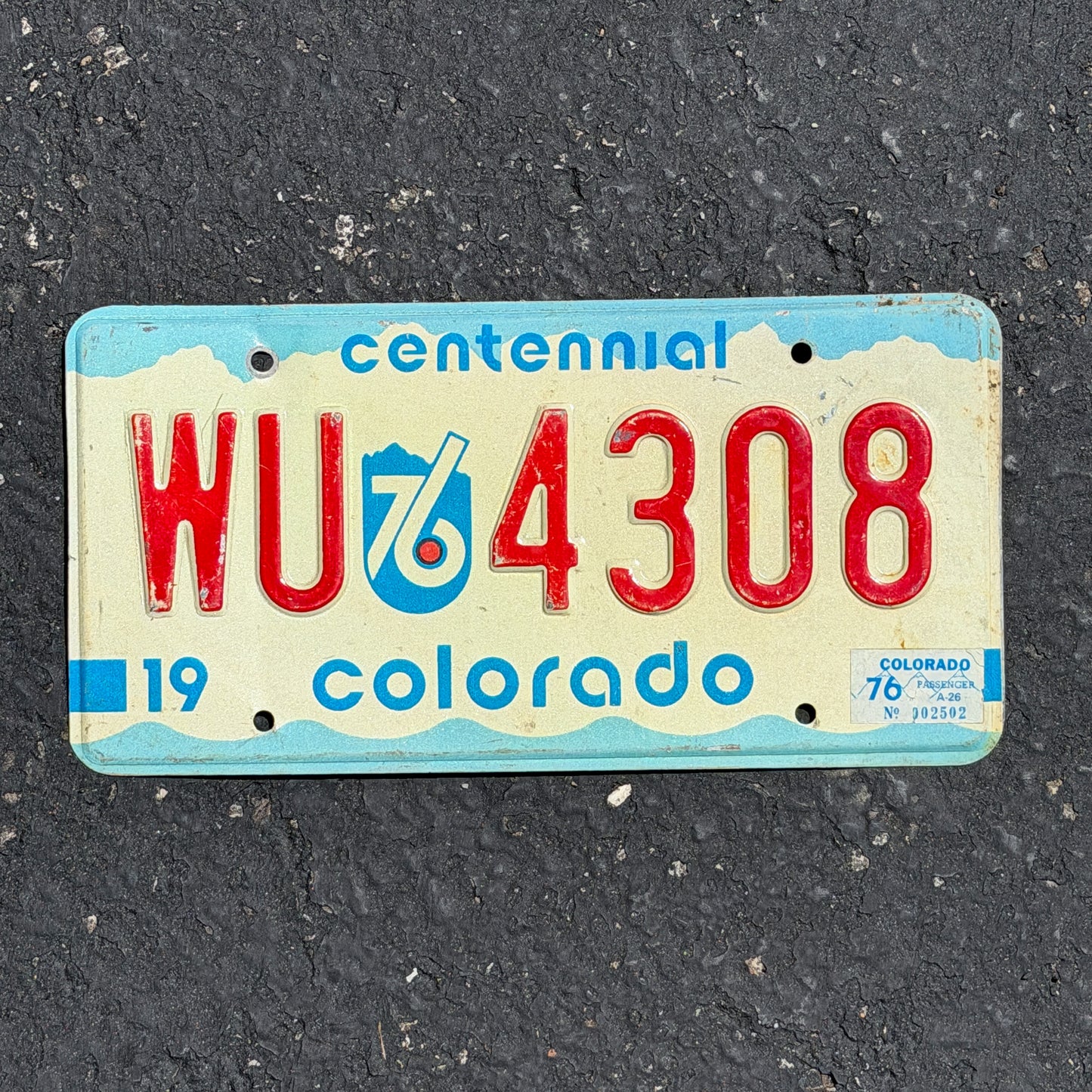Photo of a 1975 1976 Colorado License Plate Auto Tag Garage Decor Vintage Bicentennial WU 4308 with original patina