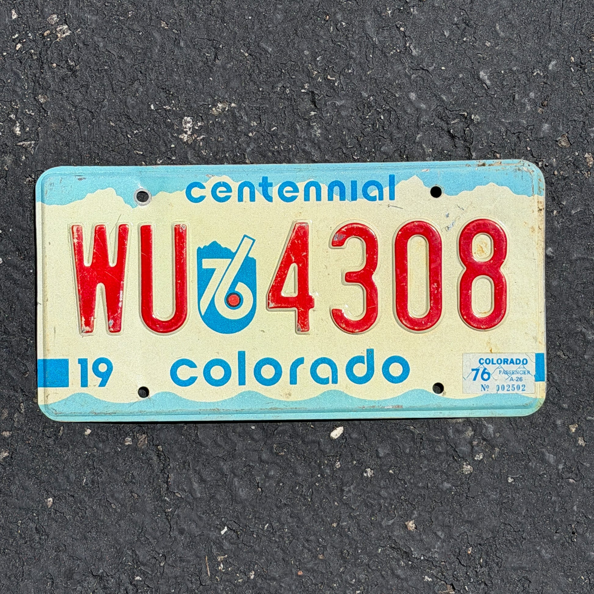 Photo of a 1975 1976 Colorado License Plate Auto Tag Garage Decor Vintage Bicentennial WU 4308 with original patina