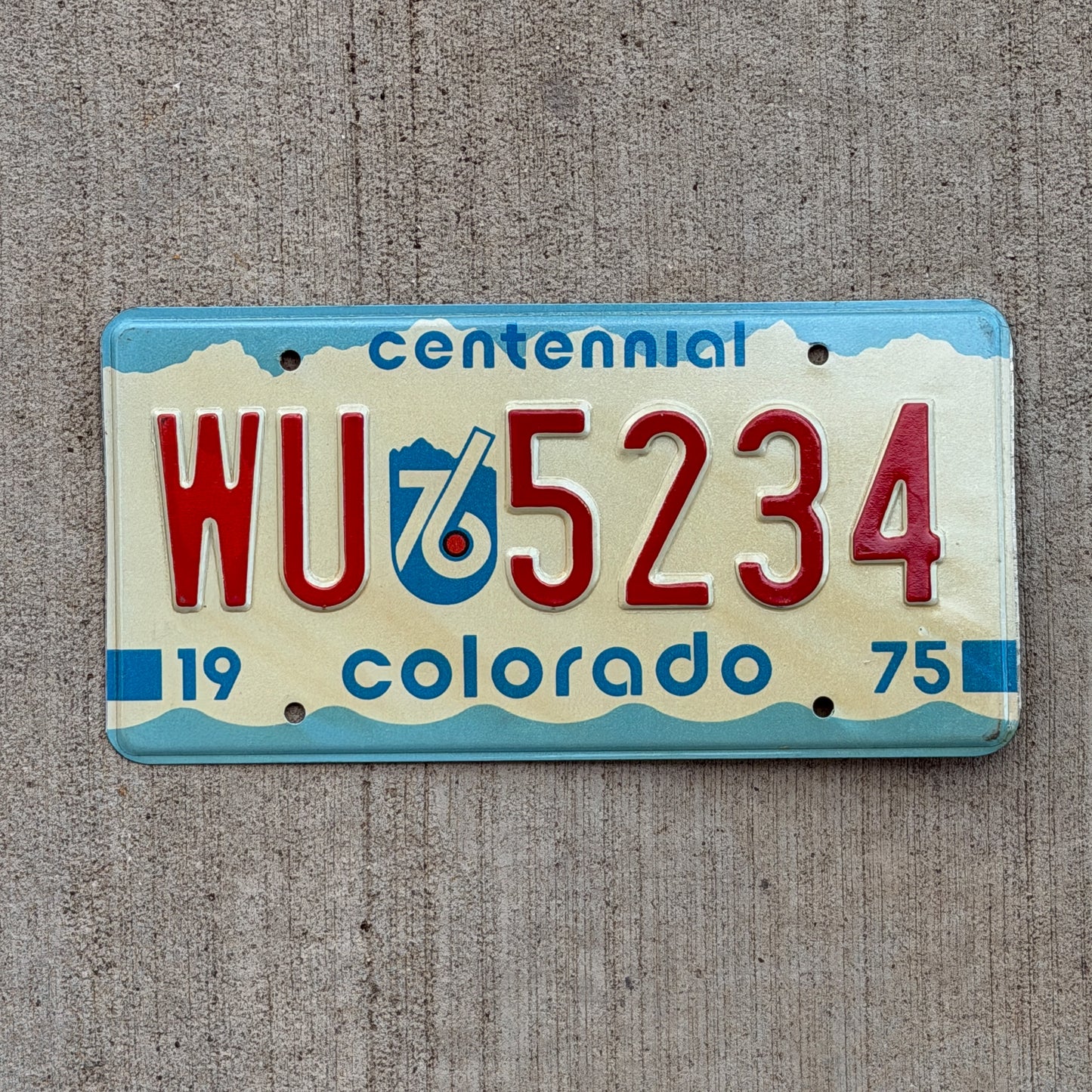 Photo of a 1975 1976 Colorado License Plate Auto Tag Garage Decor Vintage WU 5234 with original patina