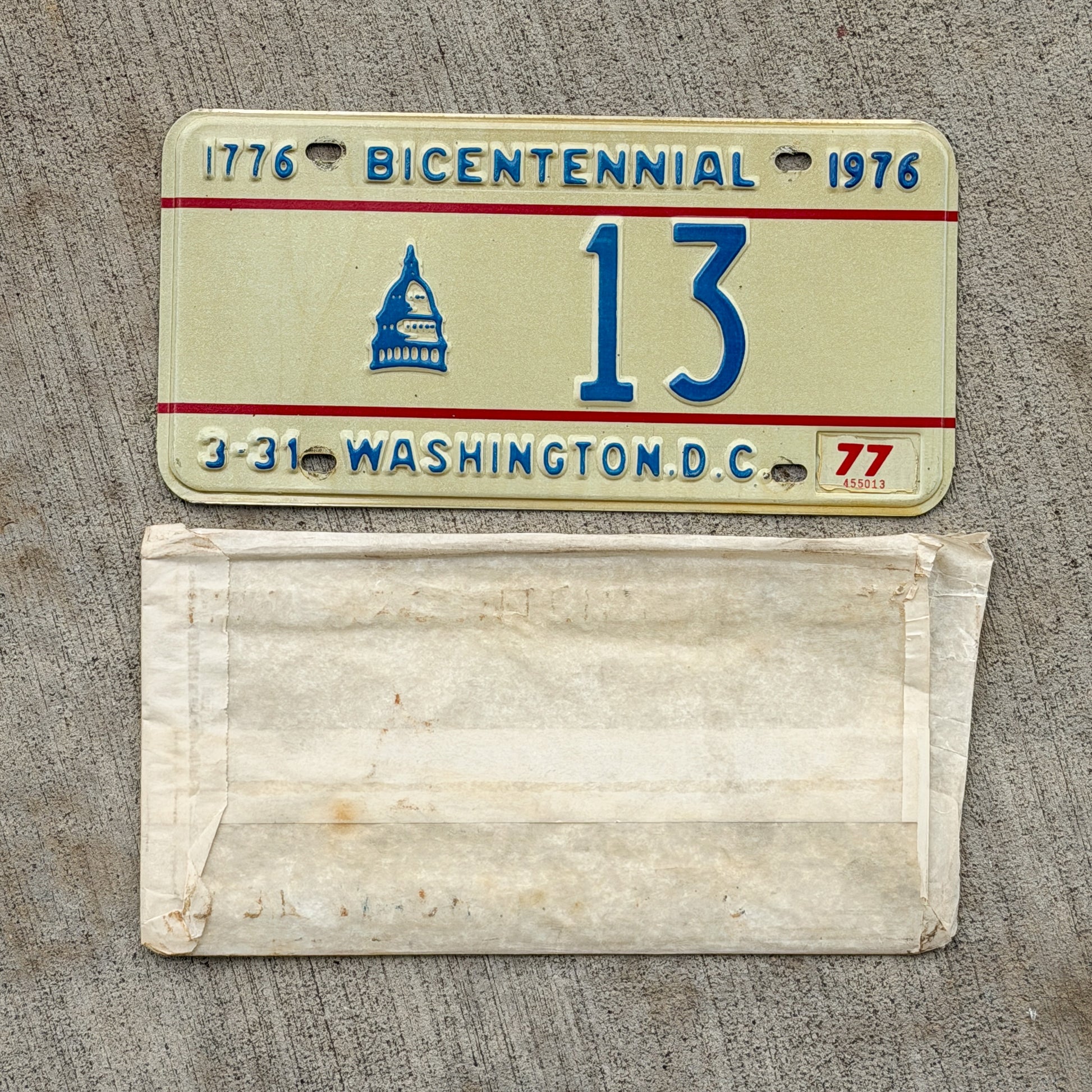 Photo of a 1975 1977 Washington DC Bicentennial License Plate Auto Tag Garage Decor Vintage Low Number Two Digit With Envelope 13 with original patina