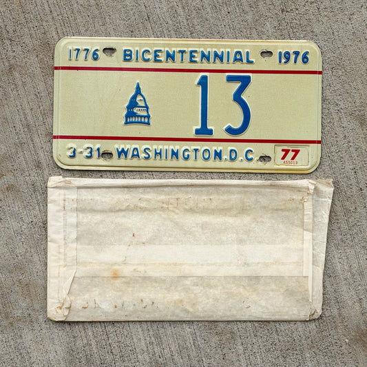 Photo of a 1975 1977 Washington DC Bicentennial License Plate Auto Tag Garage Decor Vintage Low Number Two Digit With Envelope 13 with original patina