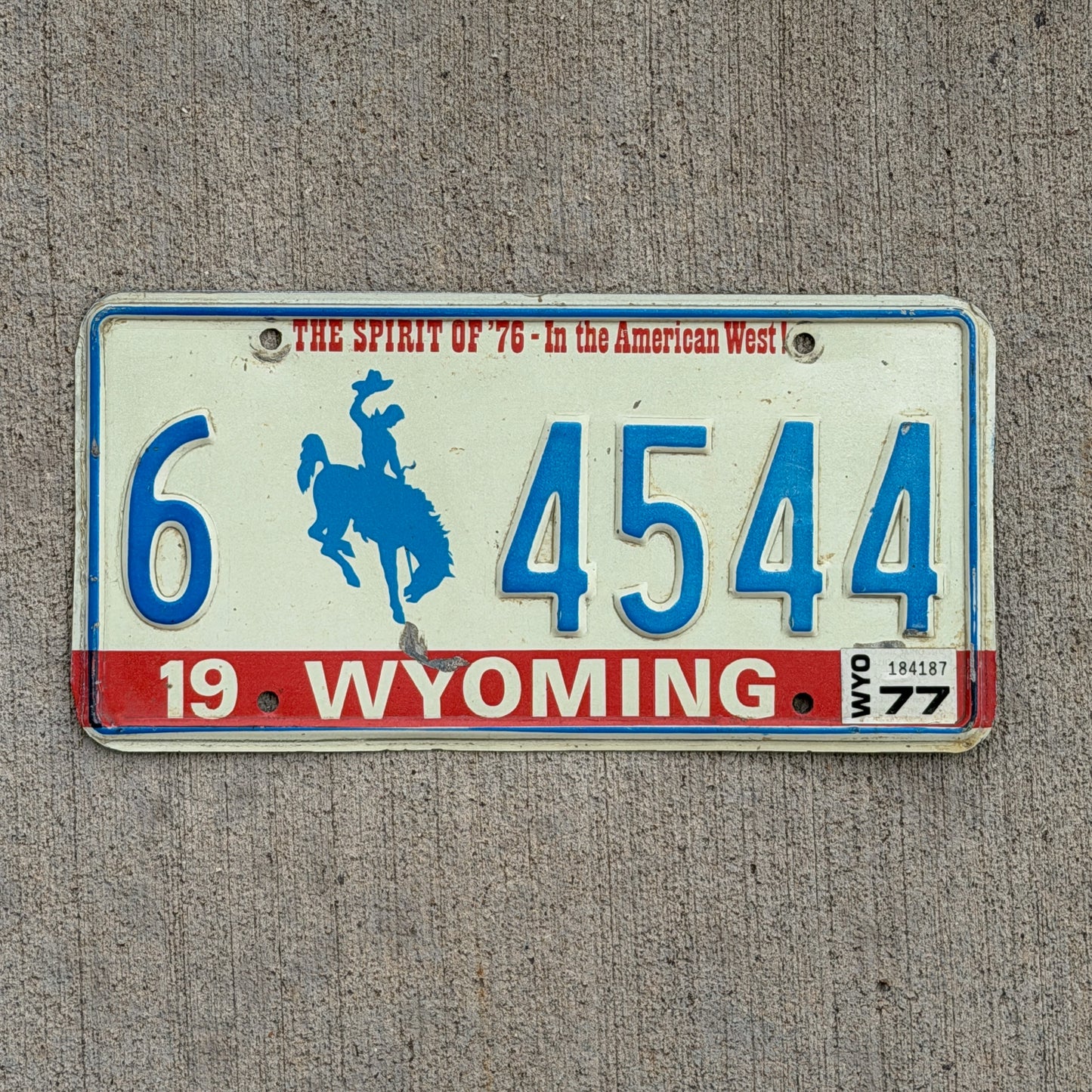 Photo of a 1975 1977 Wyoming License Plate Auto Tag 2 Vintage Garage Bicentennial Cowboy Rodeo 6 4544 with original patina