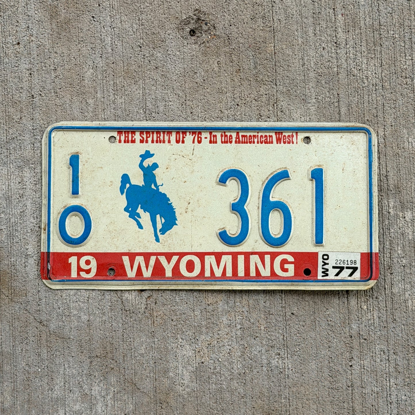 Photo of a 1975 1977 Wyoming License Plate Auto Tag Garage Decor Vintage Bicentennial Cowboy Rodeo 10 361 with original patina