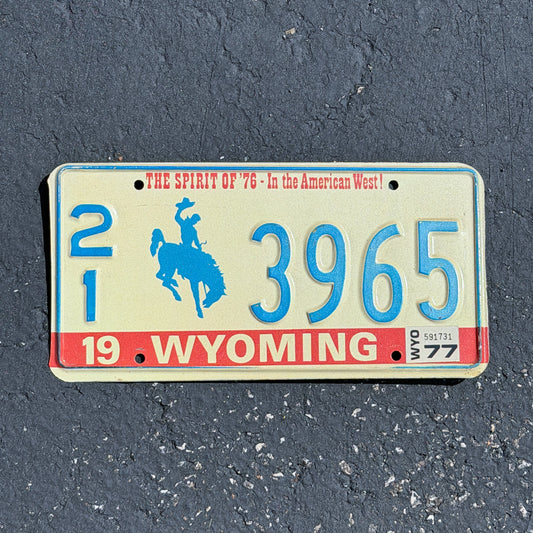 Photo of a 1975 1977 Wyoming License Plate Auto Tag Garage Decor Vintage Bicentennial Cowboy Rodeo 21 3965 with original patina