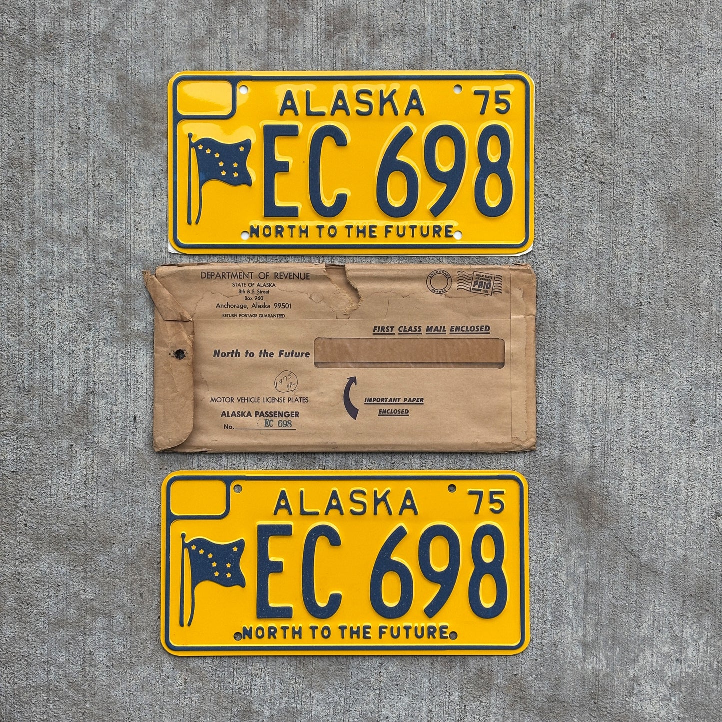 Photo of a 1975 Alaska License Plate Pair Auto Tag Garage Decor Vintage With Envelope High Quality EC 698 with original patina