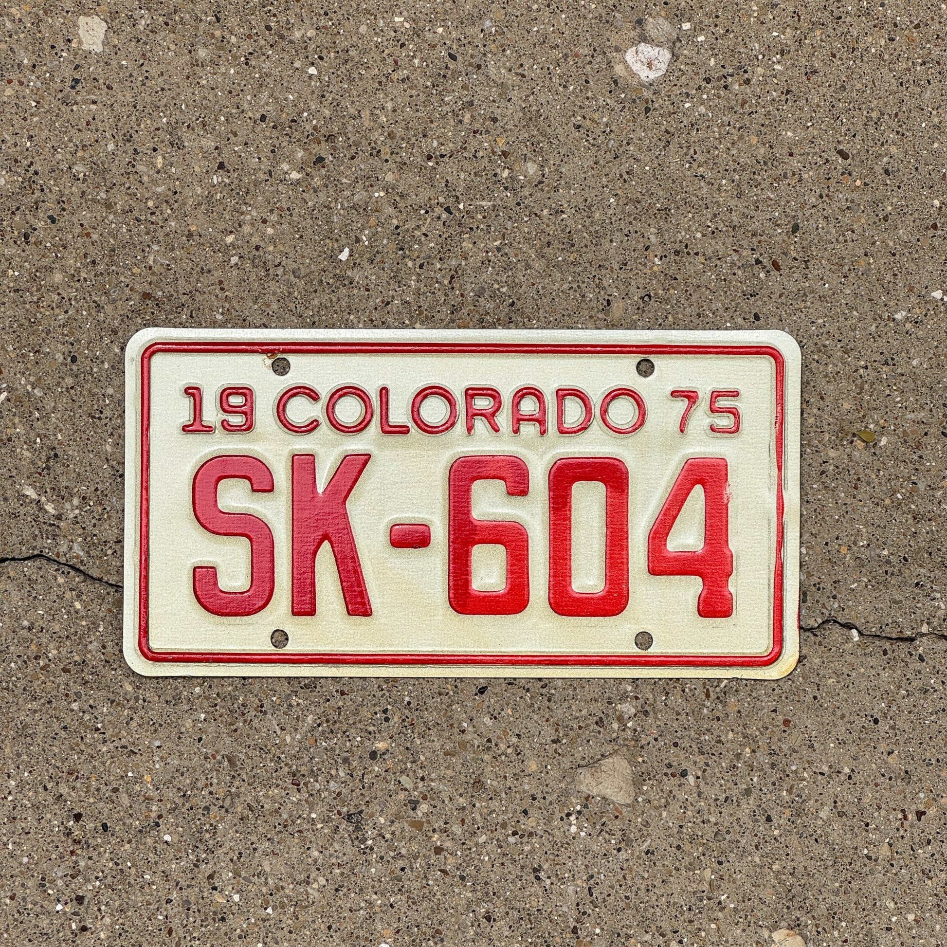 Photo of a 1975 Colorado Motorcycle License Plate Auto Tag Garage Decor Vintage SK 604