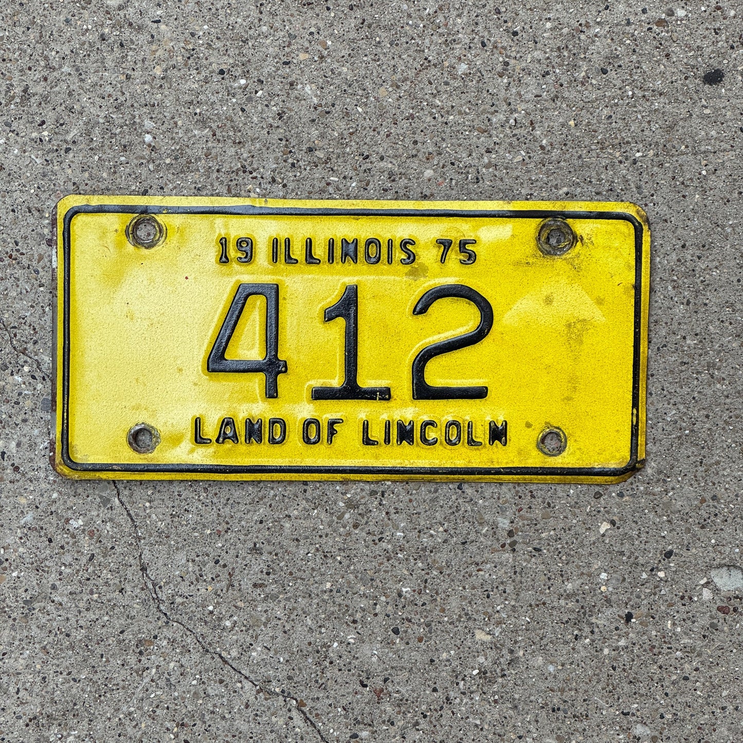Photo of a 1975 Illinois Motorcycle License Plate Auto Tag Garage Decor Vintage Low Number Three Digit 412 with original patina