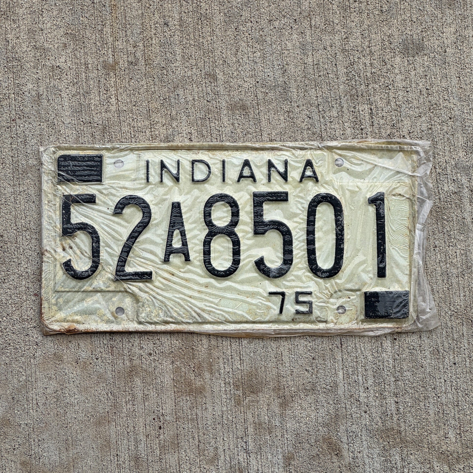 Photo of a 1975 Indiana License Plate Auto Tag Garage Decor Vintage New Old Stock 52 A 8501 with original patina