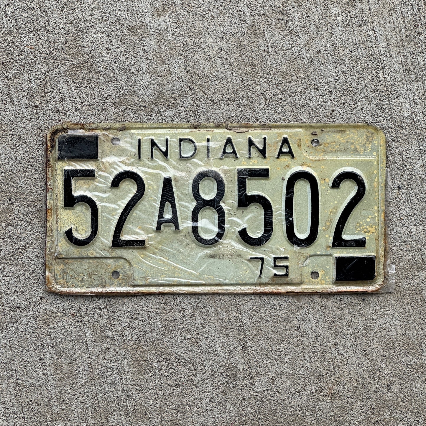 Photo of a 1975 Indiana License Plate Auto Tag Garage Decor Vintage New Old Stock 52 A 8502 with original patina