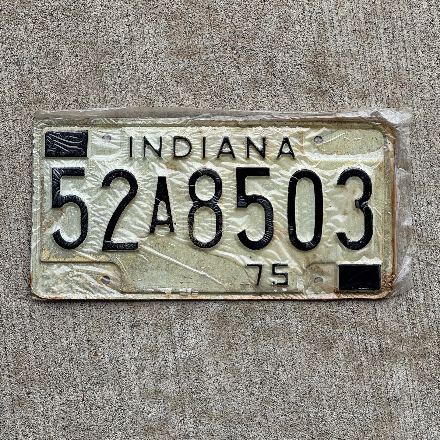 Photo of a 1975 Indiana License Plate Auto Tag Garage Decor Vintage New Old Stock 52 A 8503 with original patina