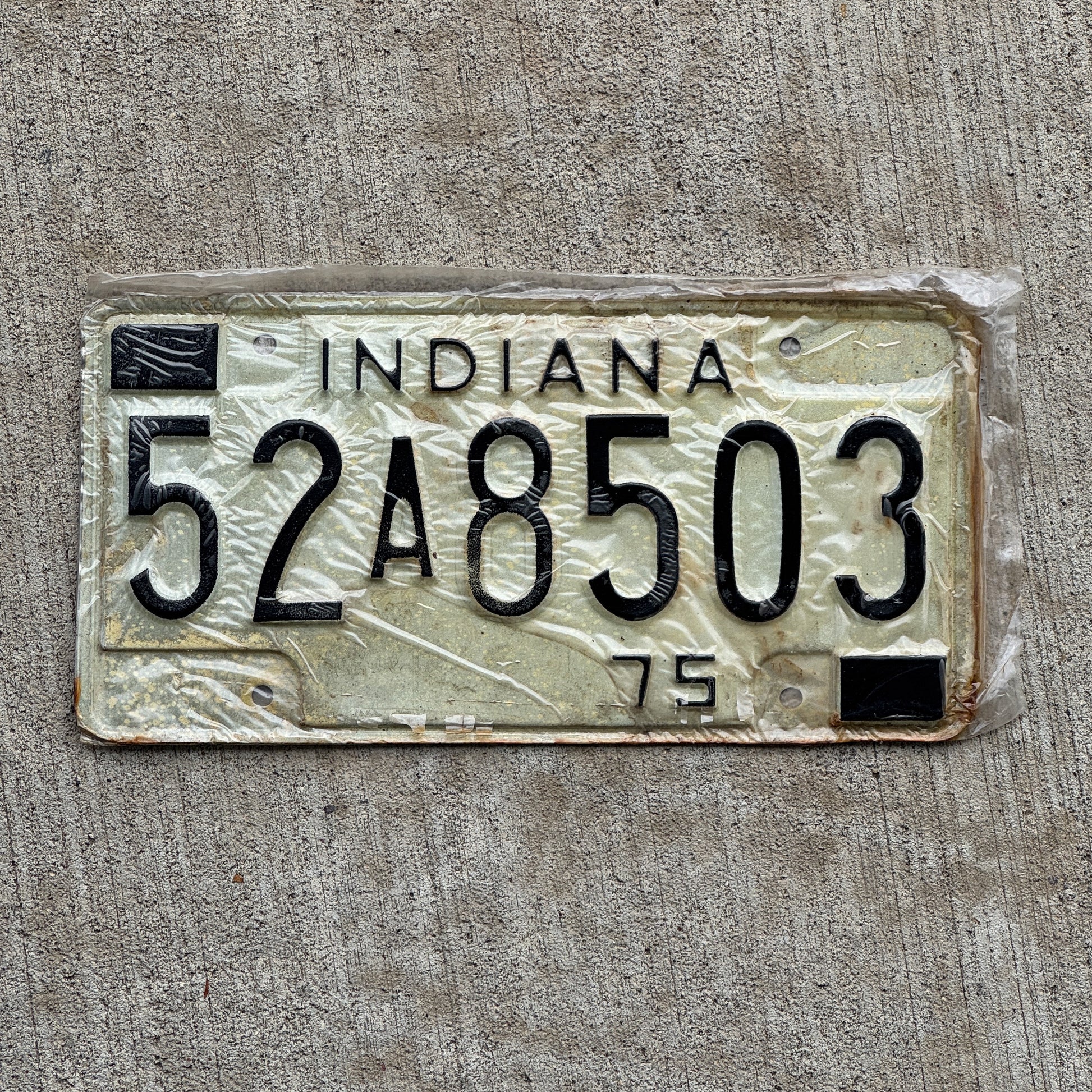 Photo of a 1975 Indiana License Plate Auto Tag Garage Decor Vintage New Old Stock 52 A 8503 with original patina