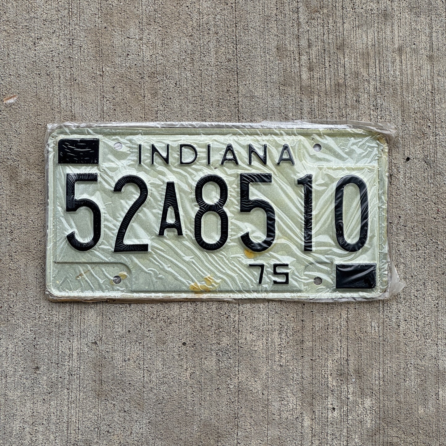 Photo of a 1975 Indiana License Plate Auto Tag Garage Decor Vintage New Old Stock 52 A 8510 with original patina
