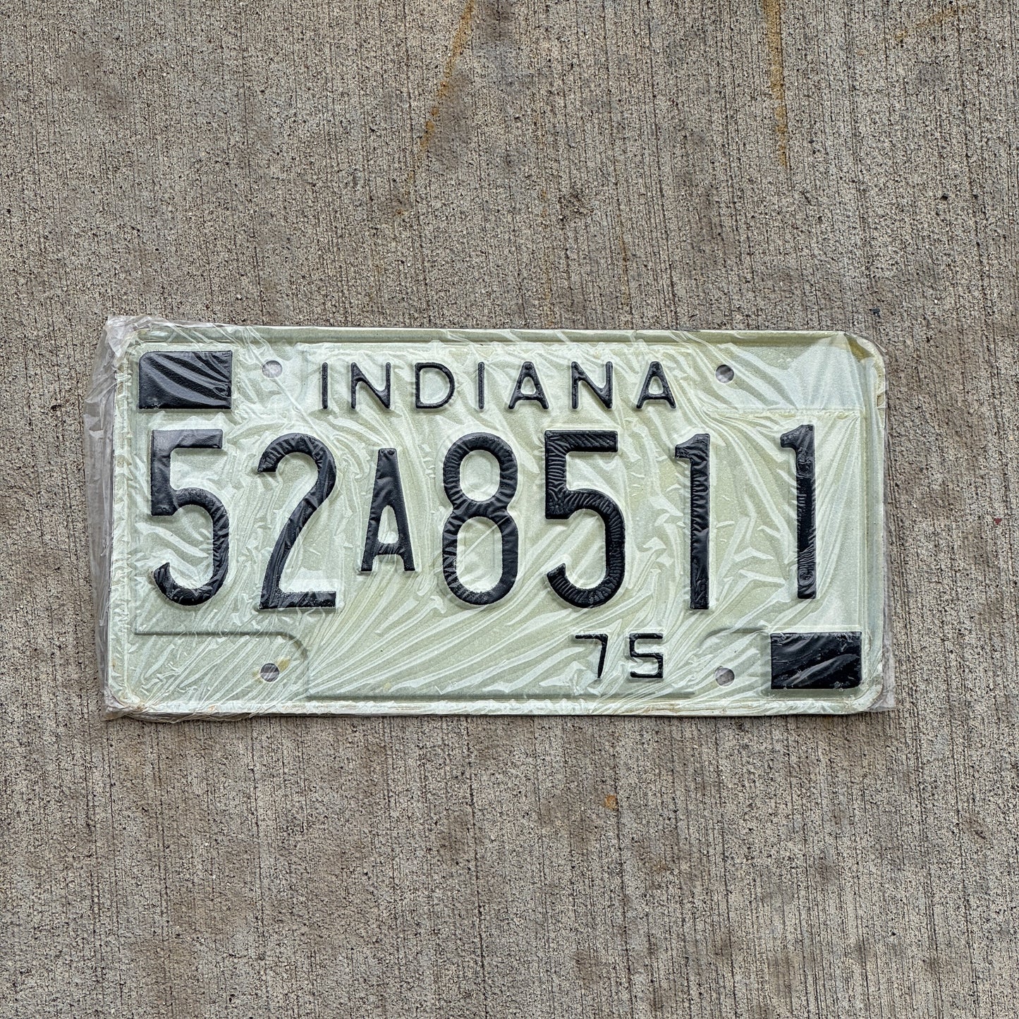 Photo of a 1975 Indiana License Plate Auto Tag Garage Decor Vintage New Old Stock 52 A 8511 with original patina