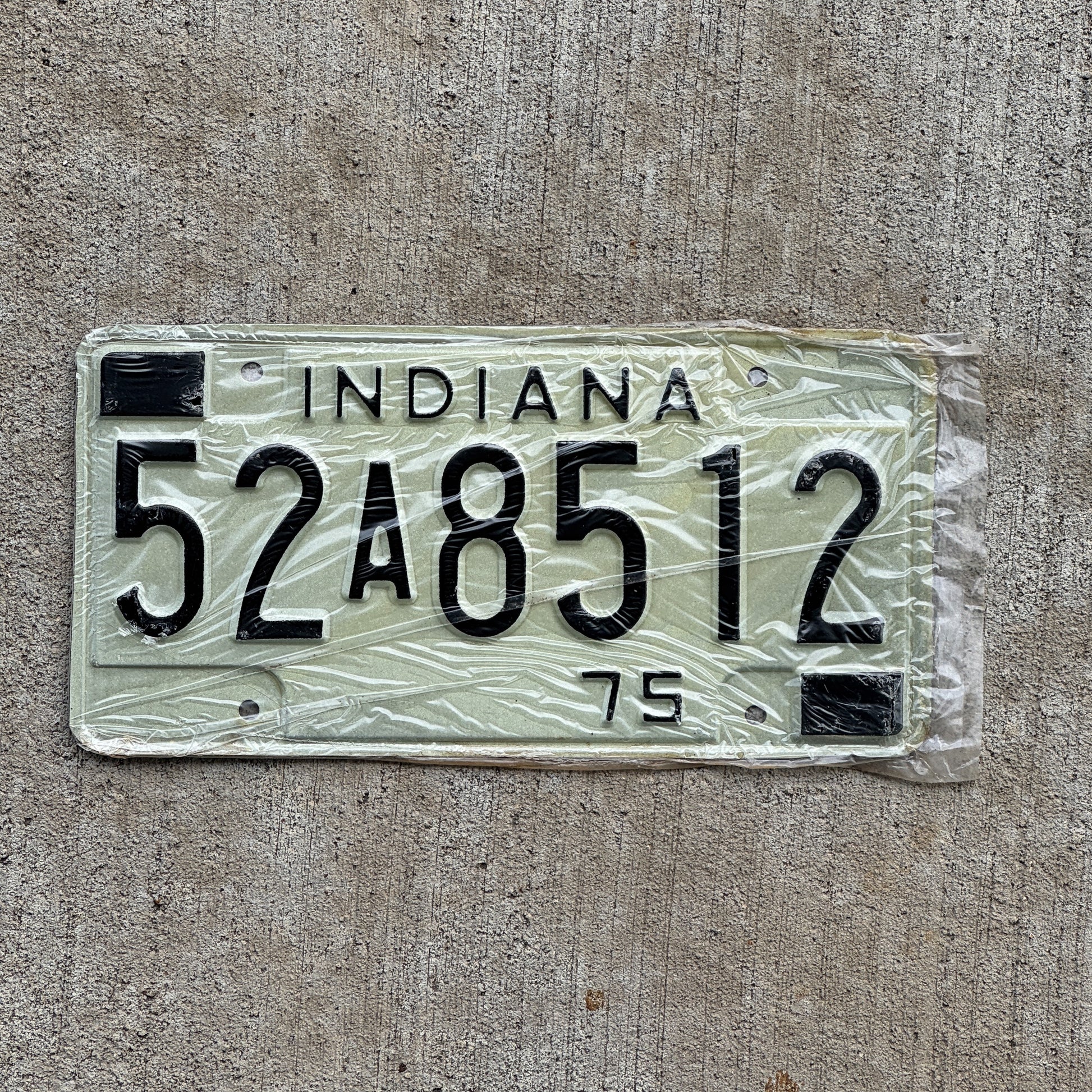 Photo of a 1975 Indiana License Plate Auto Tag Garage Decor Vintage New Old Stock 52 A 8512 with original patina