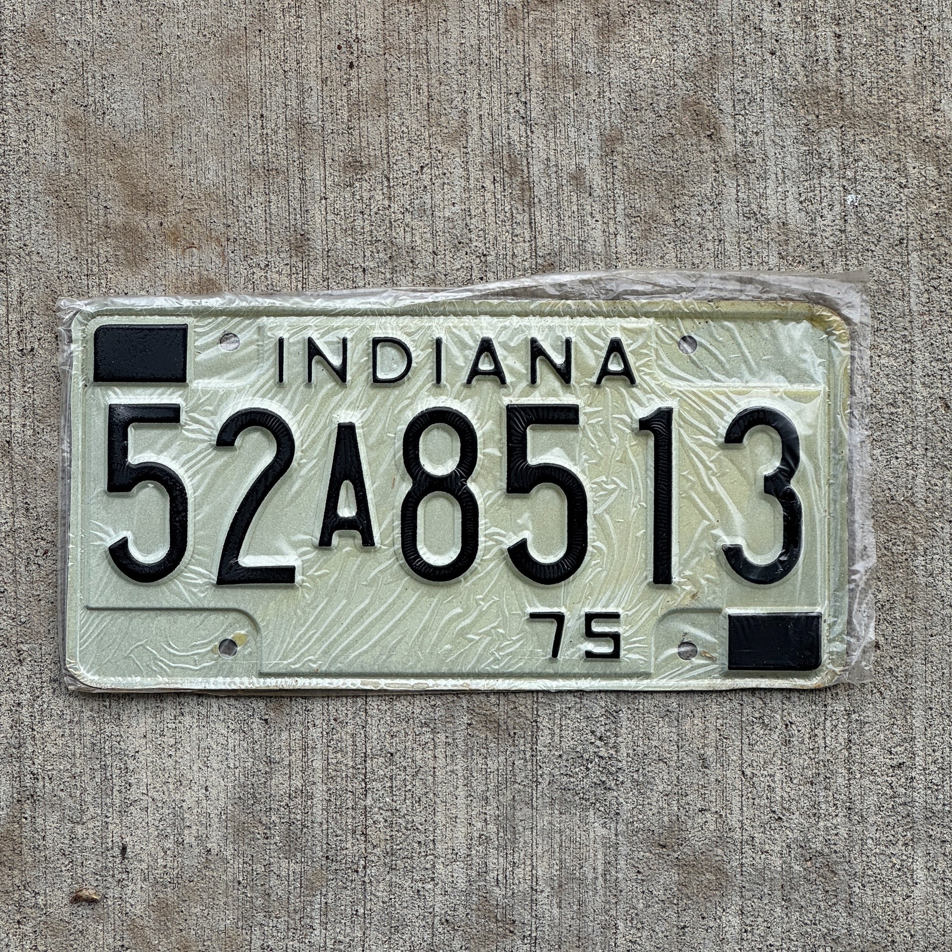 Photo of a 1975 Indiana License Plate Auto Tag Garage Decor Vintage New Old Stock 52 A 8513 with original patina
