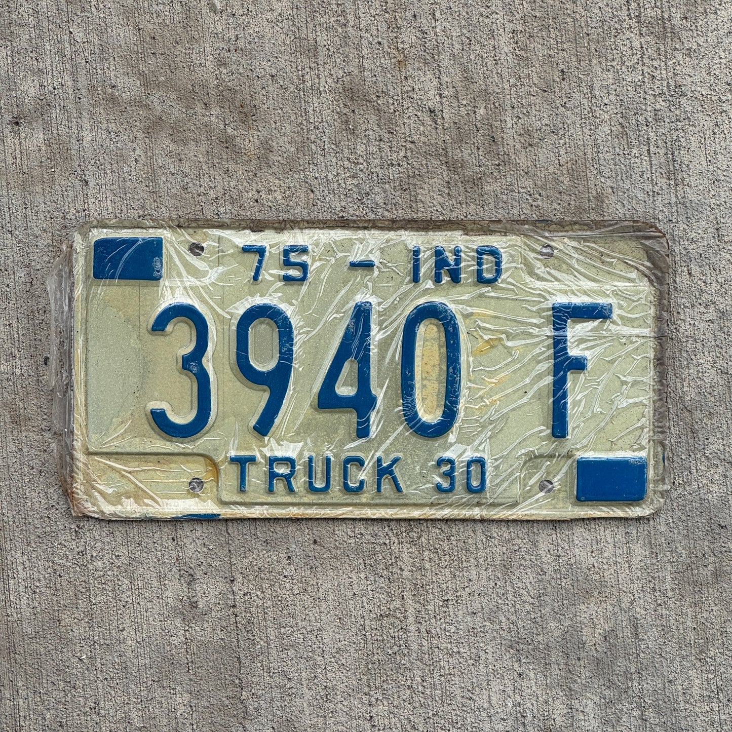 Photo of a 1975 Indiana Truck License Plate Auto Tag Garage Decor Vintage New Old Stock 3940 F with original patina