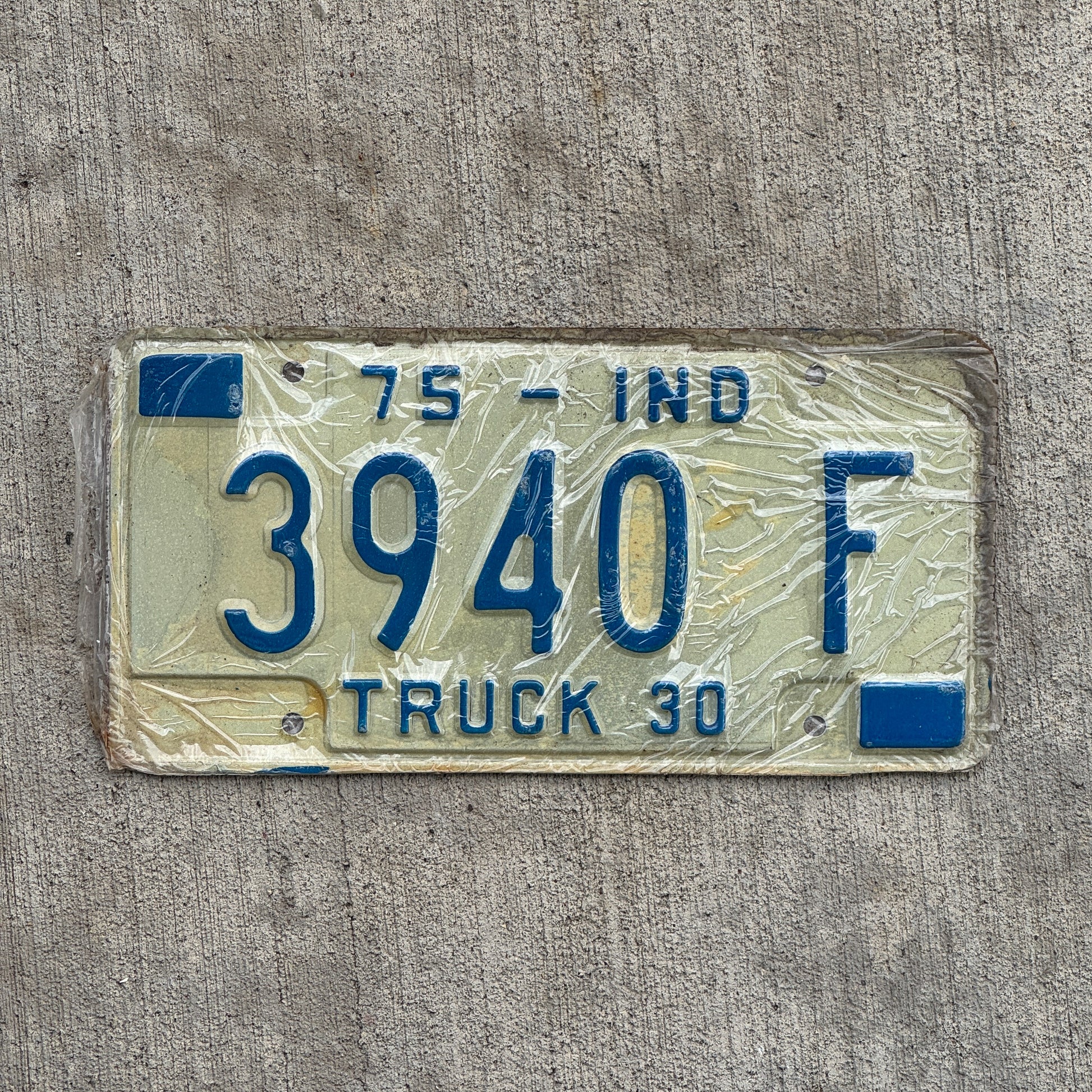 Photo of a 1975 Indiana Truck License Plate Auto Tag Garage Decor Vintage New Old Stock 3940 F with original patina