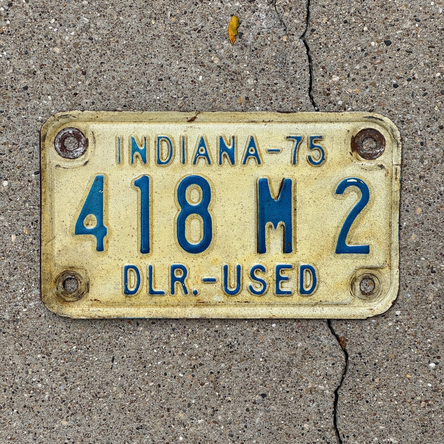 Photo of a 1975 Indiana Used Motorcycle Dealer License Plate Auto Tag Garage Decor Vintage 418 M 2 with original patina