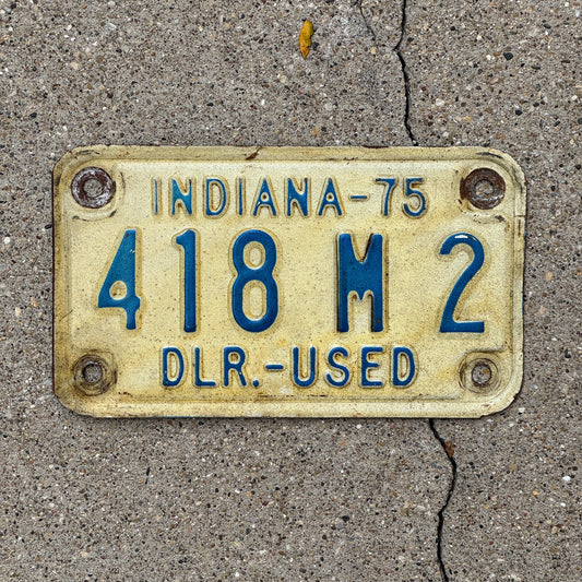 Photo of a 1975 Indiana Used Motorcycle Dealer License Plate Auto Tag Garage Decor Vintage 418 M 2 with original patina