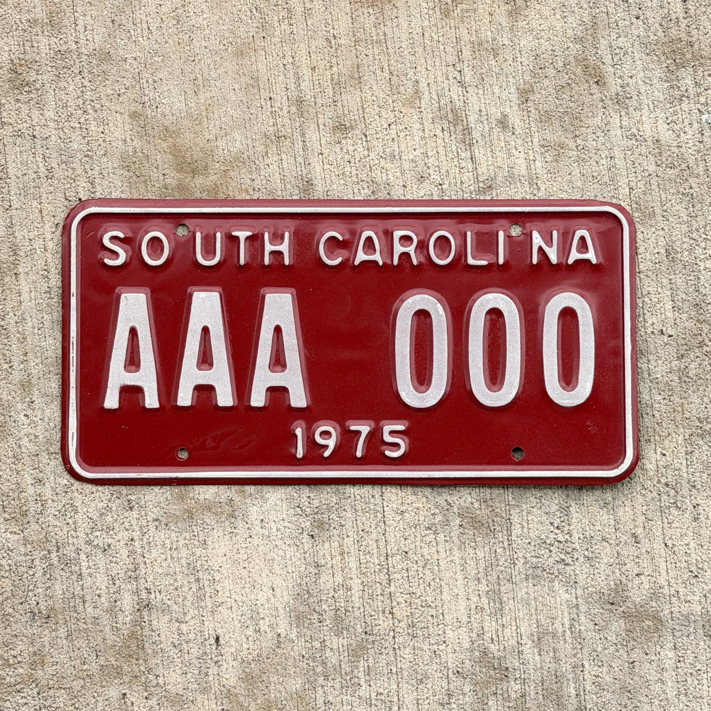 Photo of a 1975 South Carolina Sample License Plate Auto Tag Garage Decor Vintage AAA 000 with original patina