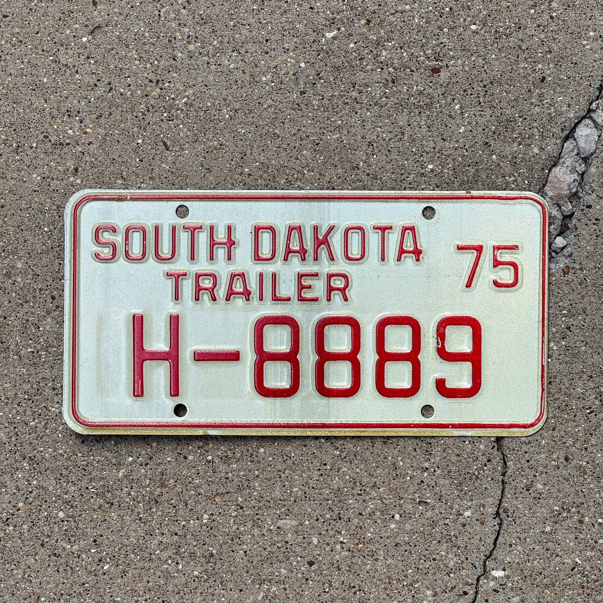 Photo of a 1975 South Dakota Trailer License Plate Auto Tag Garage Decor Vintage Repeat Repeating H 888 9