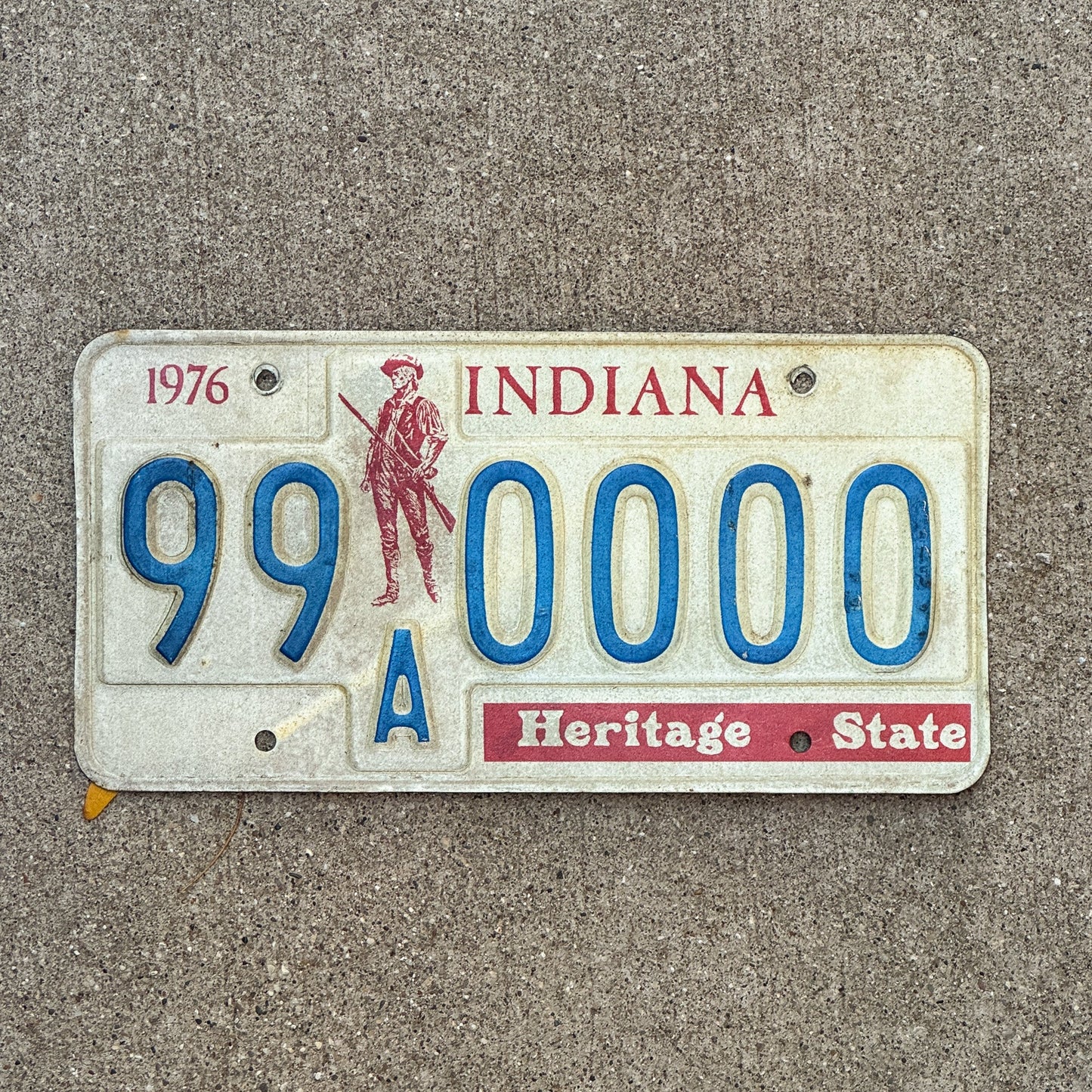 Photo of a 1976 1977 Indiana Sample License Plate Auto Tag 3 Vintage 99A0000 with original patina