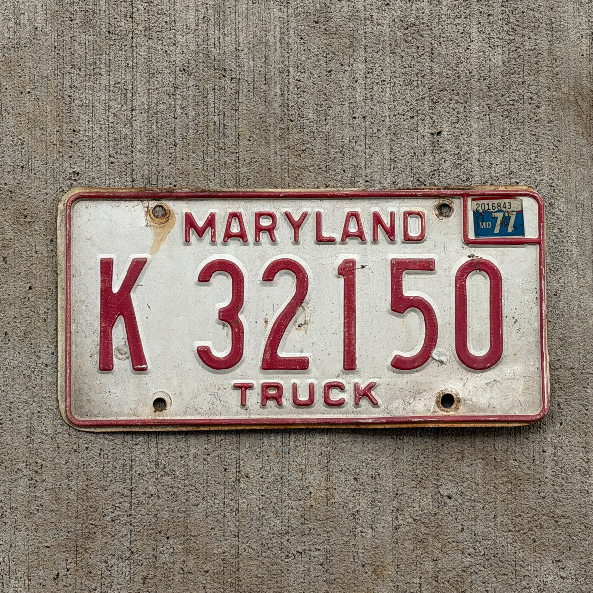 Photo of a 1976 1977 Maryland Truck License Plate Auto Tag Garage Decor Vintage K 32150 with original patina