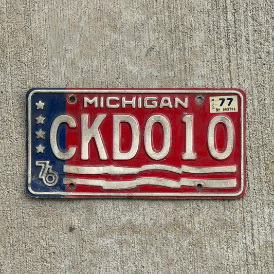 Photo of a 1976 1977 Michigan License Plate Auto Tag Garage Decor Vintage Bicentennial CKD 010 with original patina