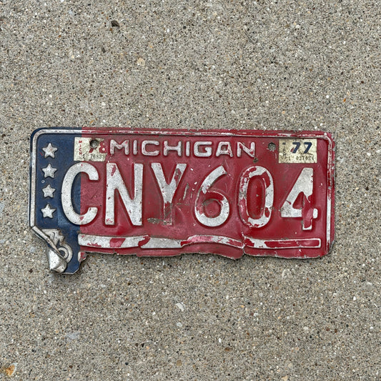 Photo of a 1976 1977 Michigan License Plate Auto Tag Garage Decor Vintage Bicentennial CNV 604 with original patina