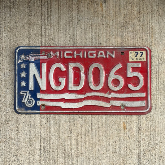 Photo of a 1976 1977 Michigan License Plate Auto Tag Garage Decor Vintage Bicentennial NGD 065 with original patina